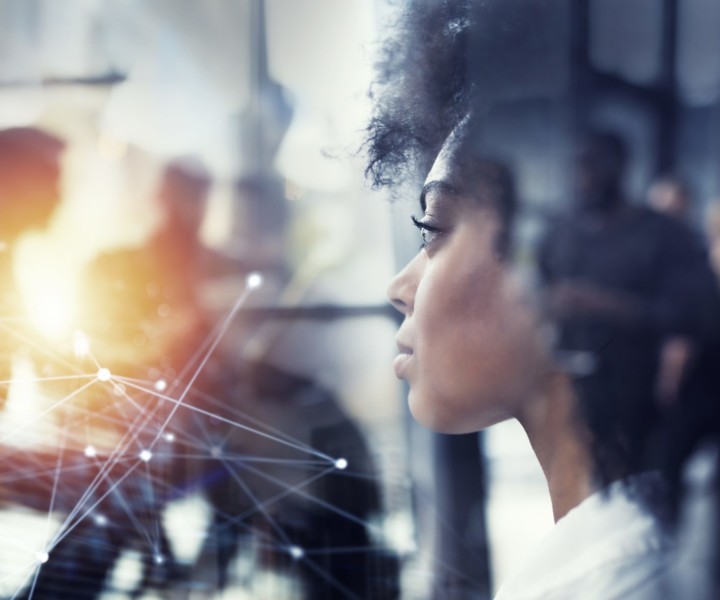 Businesswoman at the office looks far through the window for the future. double exposure