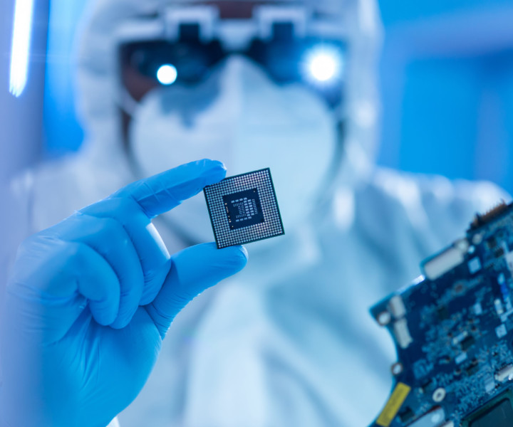 Professional African-American scientist works in a modern scientific laboratory for the research and development of microelectronics and processors. Microprocessor manufacturing worker uses computer technology and equipment.