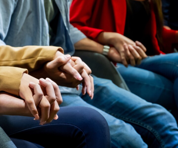 Group of people holding hand together , Group psychotherapy scene